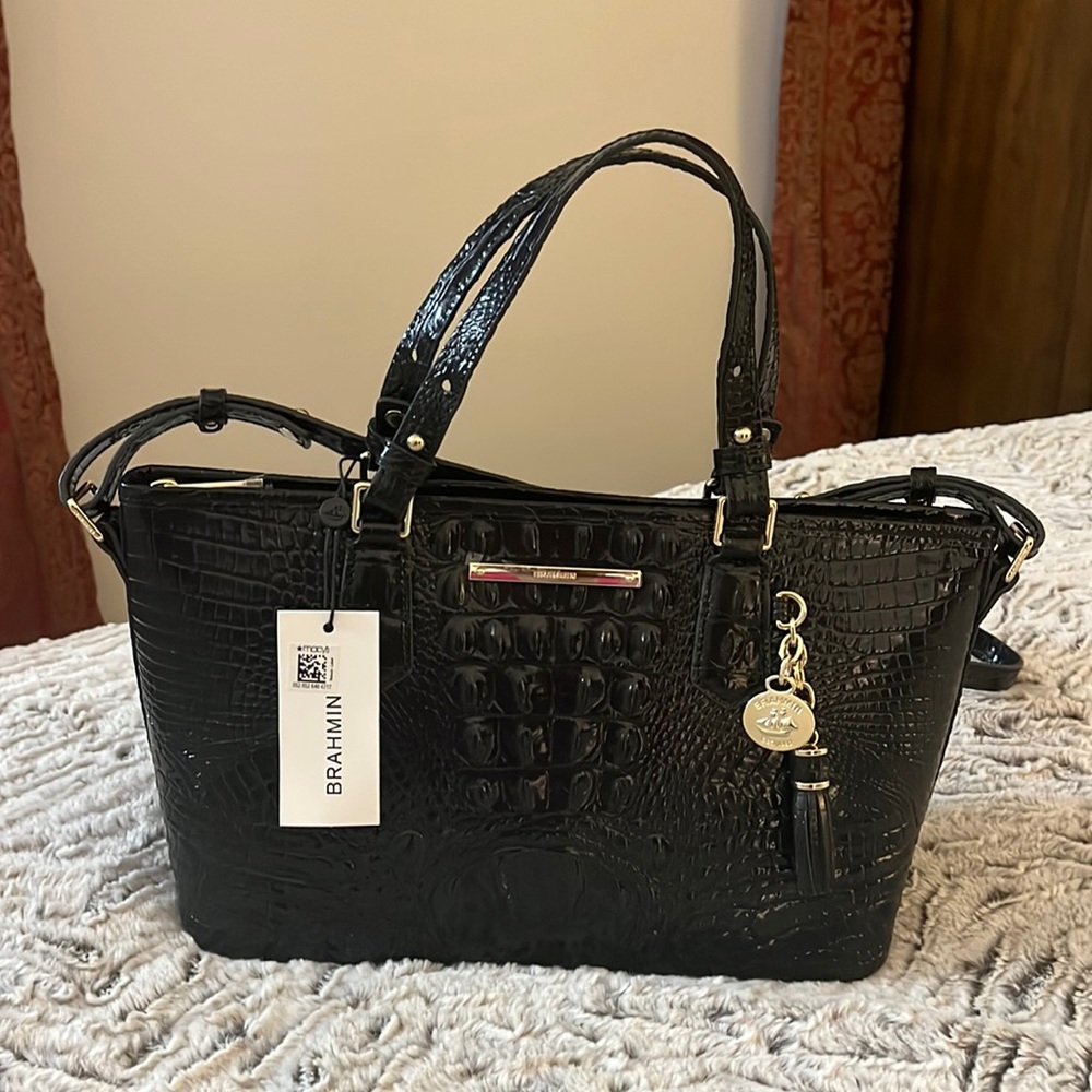 Selling my Brahmin Mini Asher Genuine Leather. The color is black . Brand new